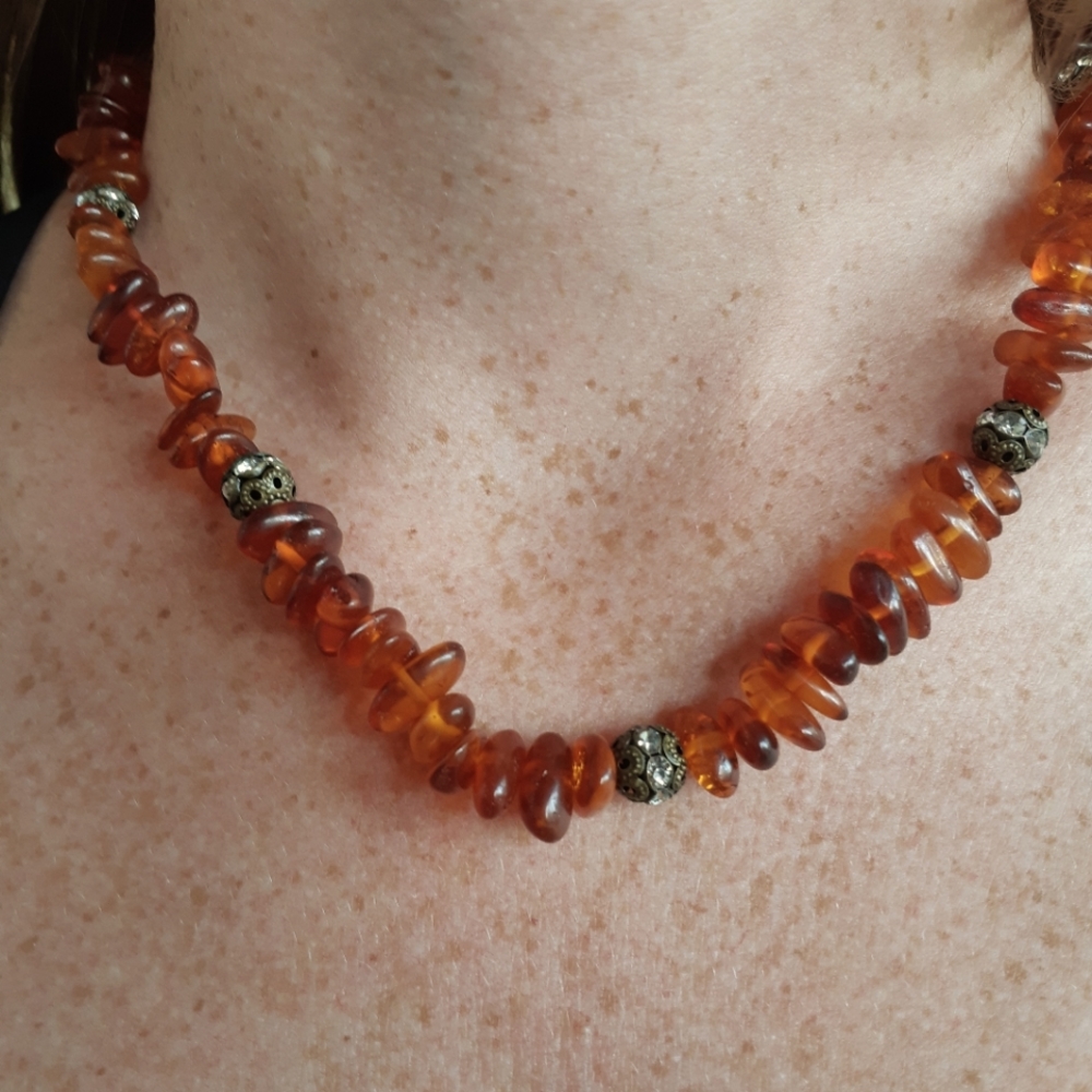 Baltic amber with antique spacers in brass and rhinestones.